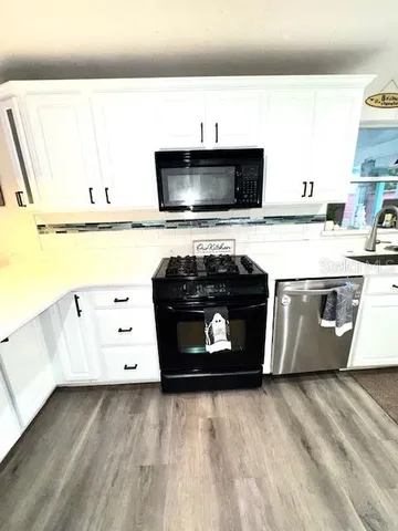 a kitchen with a stove and a microwave
