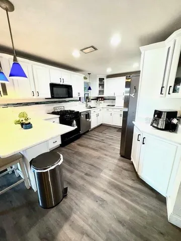 a kitchen with a sink cabinets and window