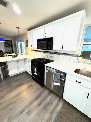 a kitchen with a sink and a stove top oven