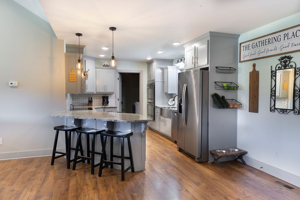 1701 Rock Bridge Road Bethpage, TN 37022 - Photo 5 of 29 a kitchen with stainless steel appliances a dining table chairs refrigerator and sink