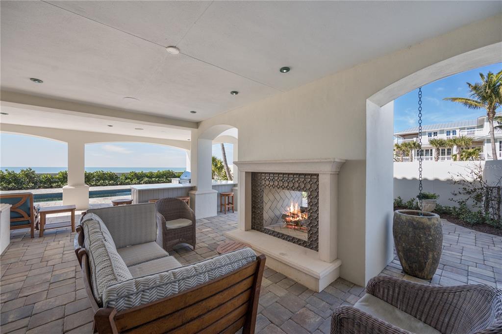 200 Banyan Street Boca Grande, FL 33921 - Photo 37 of 39 a living room with furniture a flat screen tv and a fireplace