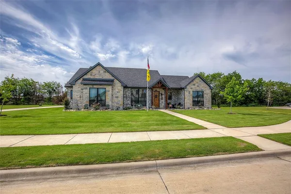 a front view of a house with a yard
