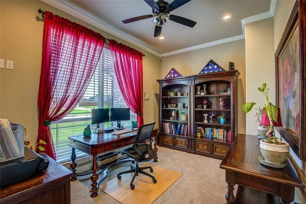 a living room with furniture a bookshelf and a window