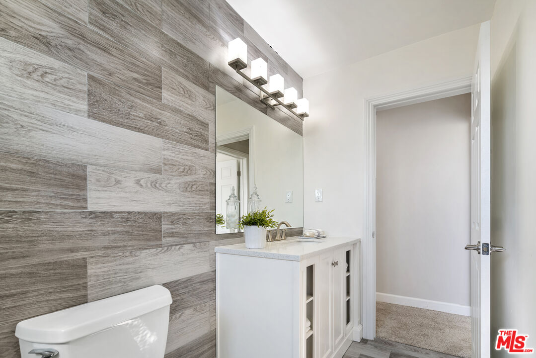 18147 Coastline Drive, Unit 6 Malibu, CA 90265 - Photo 14 of 26 a bathroom with a sink vanity mirror and toilet