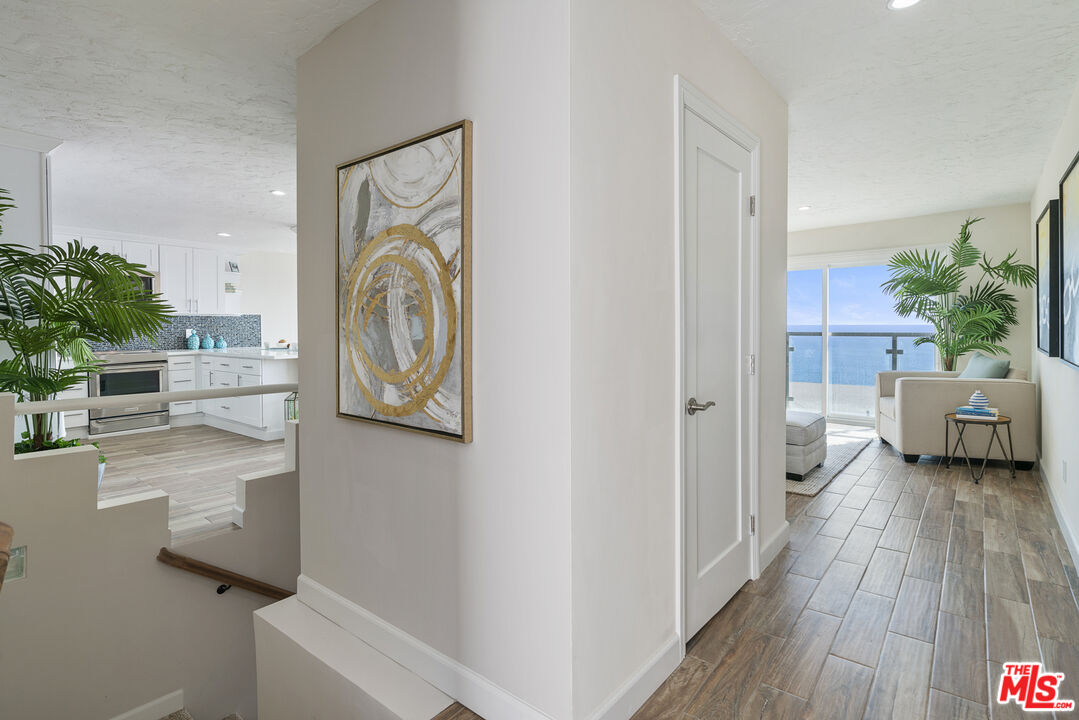 18147 Coastline Drive, Unit 6 Malibu, CA 90265 - Photo 17 of 26 a view of a hallway and a livingroom with furniture