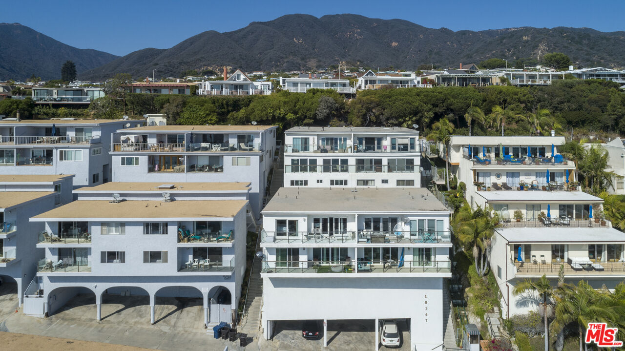 18147 Coastline Drive, Unit 6 Malibu, CA 90265 - Photo 19 of 26 a view of a large building with a mountain