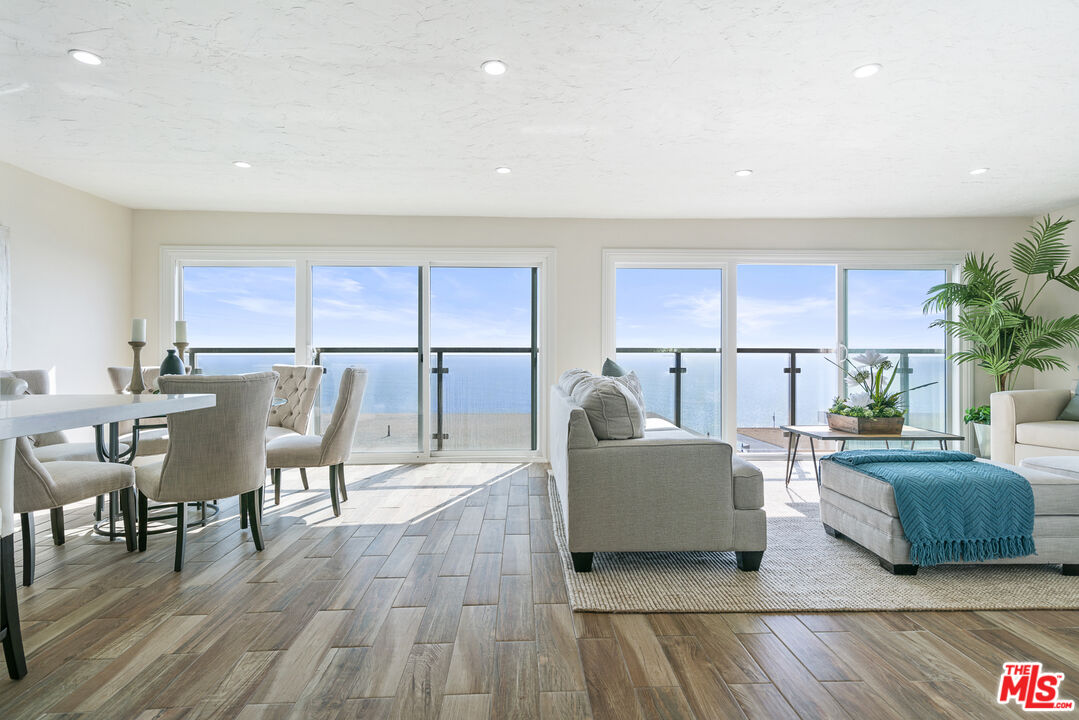 18147 Coastline Drive, Unit 6 Malibu, CA 90265 - Photo 4 of 26 a living room with furniture and a wooden floor