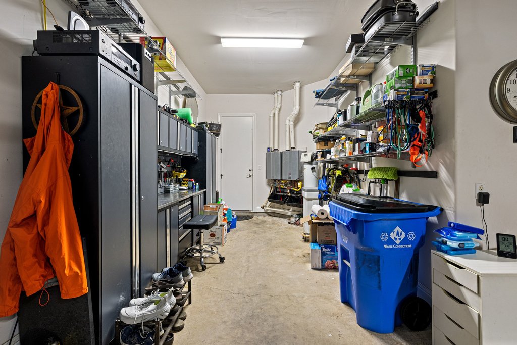 215 Lodestone Lane Austin, TX 78738 - Photo 33 of 40 Functional garage offering built-in storage solutions and dedicated workspace.