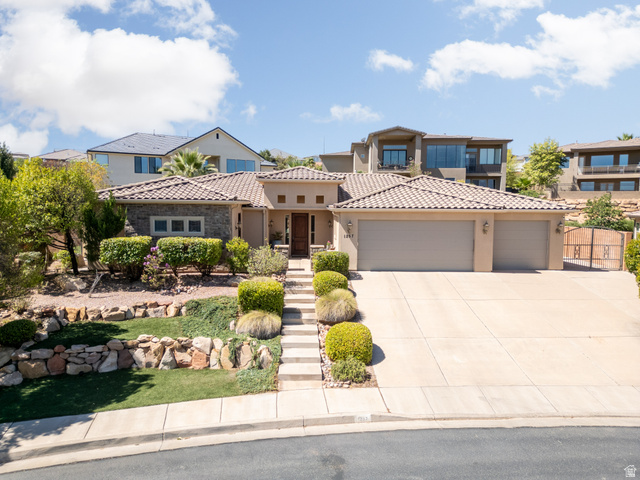 1257 West 2320 South St. George, UT 84770 - Photo 1 of 55 Stucco exterior with a tile roof, featuring a three-car garage and a stone-accented facade