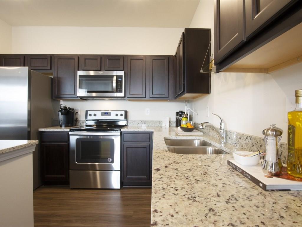 Kitchen - Included in this home- The same Cabinet, appliances, granite counter top, sink, faucet but not the frig. Photo is not of actual home.
