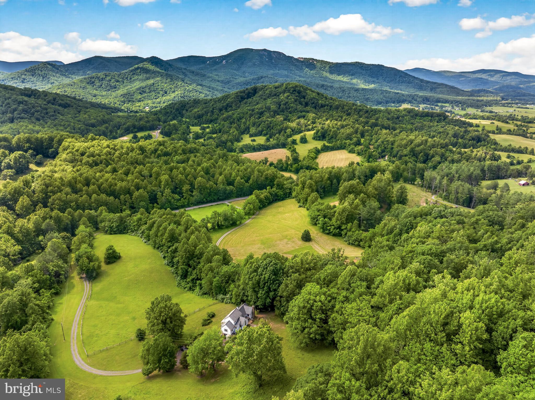 4028 South F T Valley Road Etlan, VA 22719 - Photo 18 of 101 a view of a lush green hillside and a houses