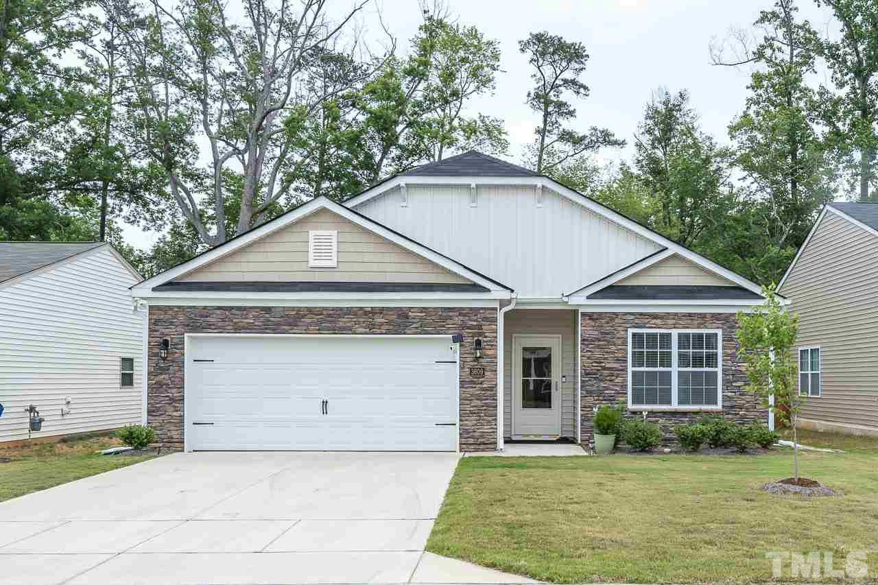 3609 Waleback Lane Raleigh, NC 27610 - Photo 1 of 18 a front view of a house with a yard and garage