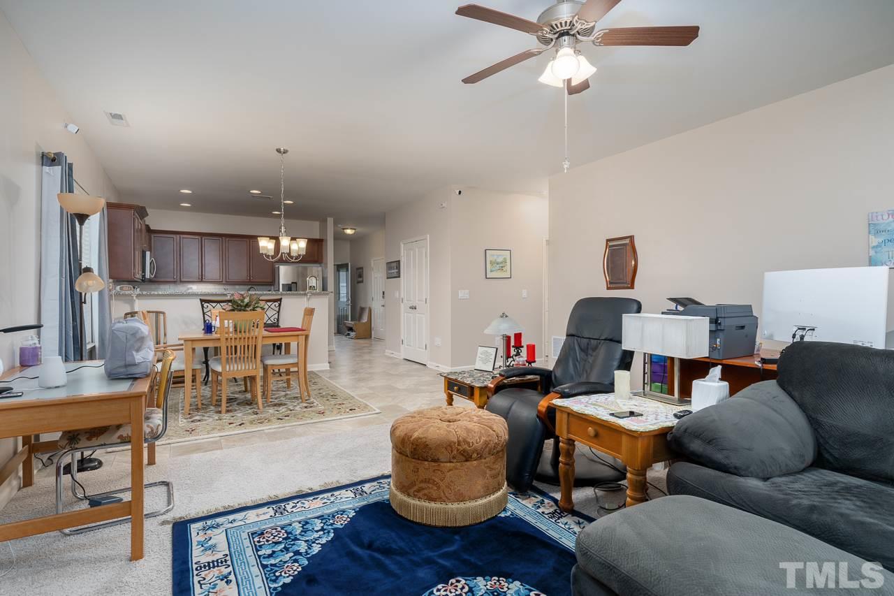 3609 Waleback Lane Raleigh, NC 27610 - Photo 2 of 18 a living room with furniture kitchen view and a chandelier