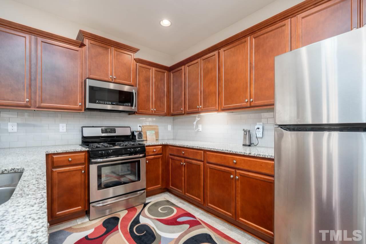 3609 Waleback Lane Raleigh, NC 27610 - Photo 5 of 18 a kitchen with stainless steel appliances granite countertop a refrigerator sink and stove