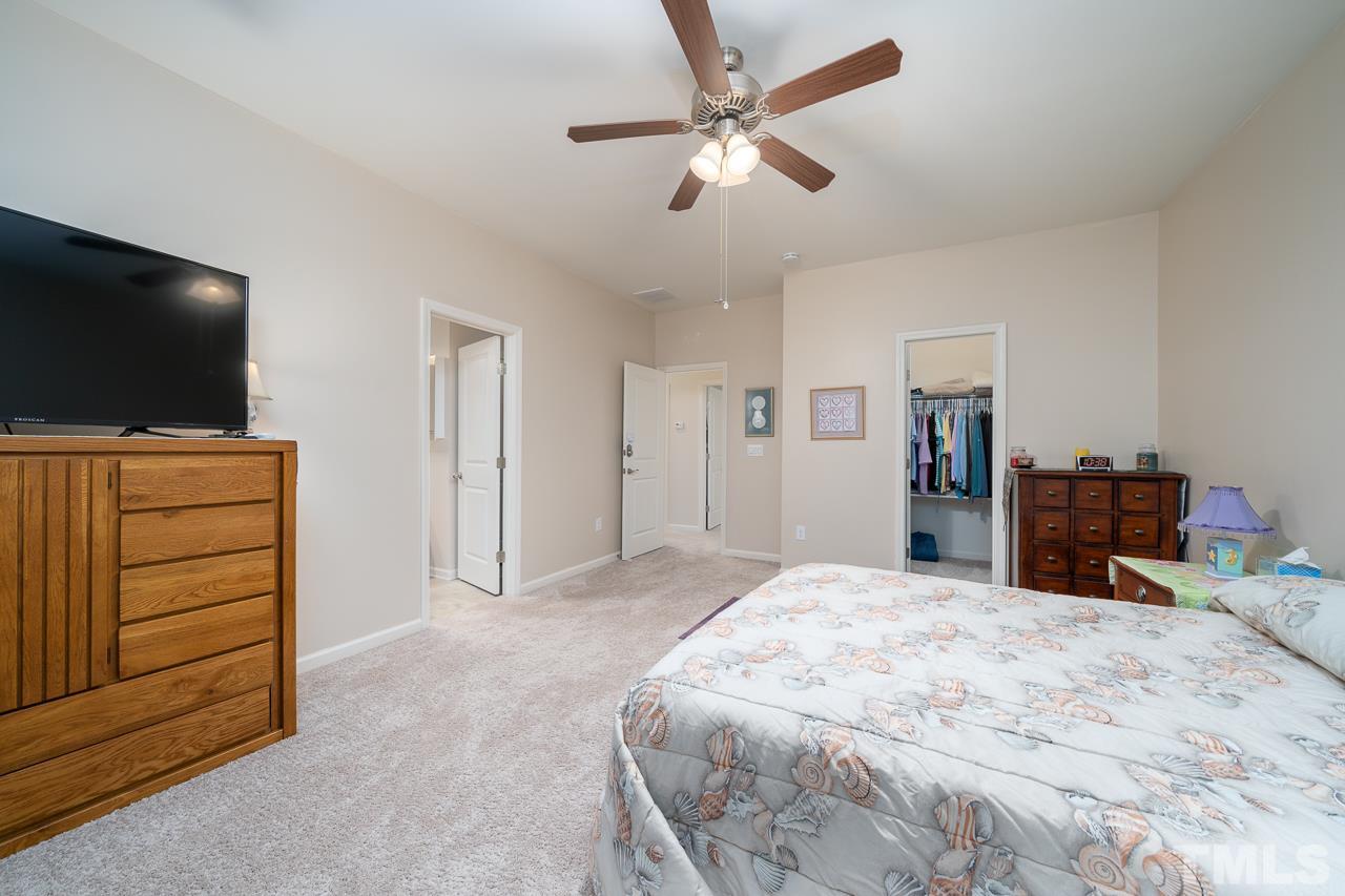 3609 Waleback Lane Raleigh, NC 27610 - Photo 8 of 18 a bedroom with a bed and a flat screen tv