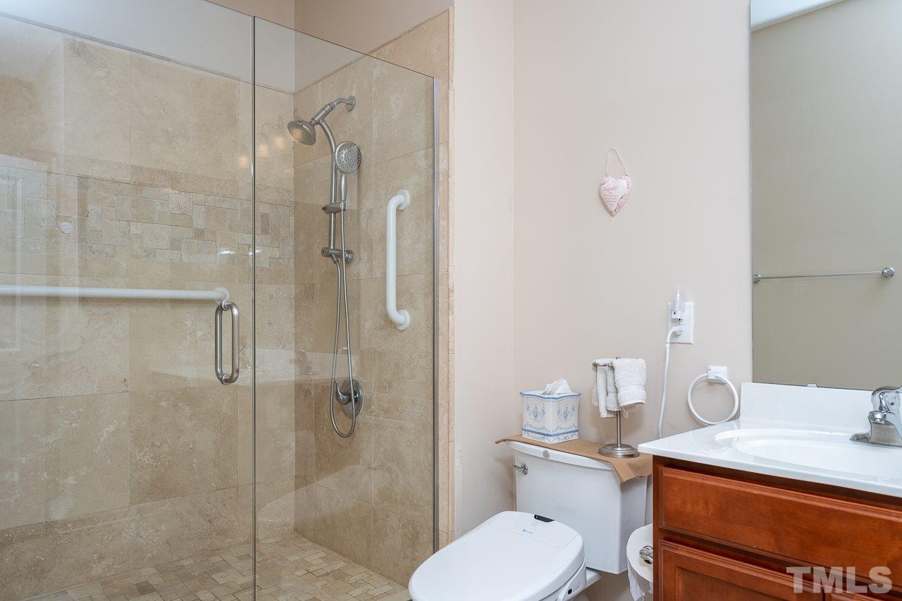 3609 Waleback Lane Raleigh, NC 27610 - Photo 10 of 18 a bathroom with a granite countertop toilet sink and shower
