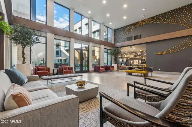 a living room with furniture and a floor to ceiling window