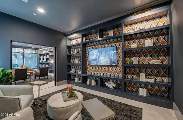 a living room with furniture a rug and a book shelf