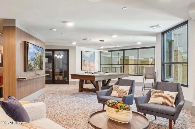 a living room with furniture and a large window