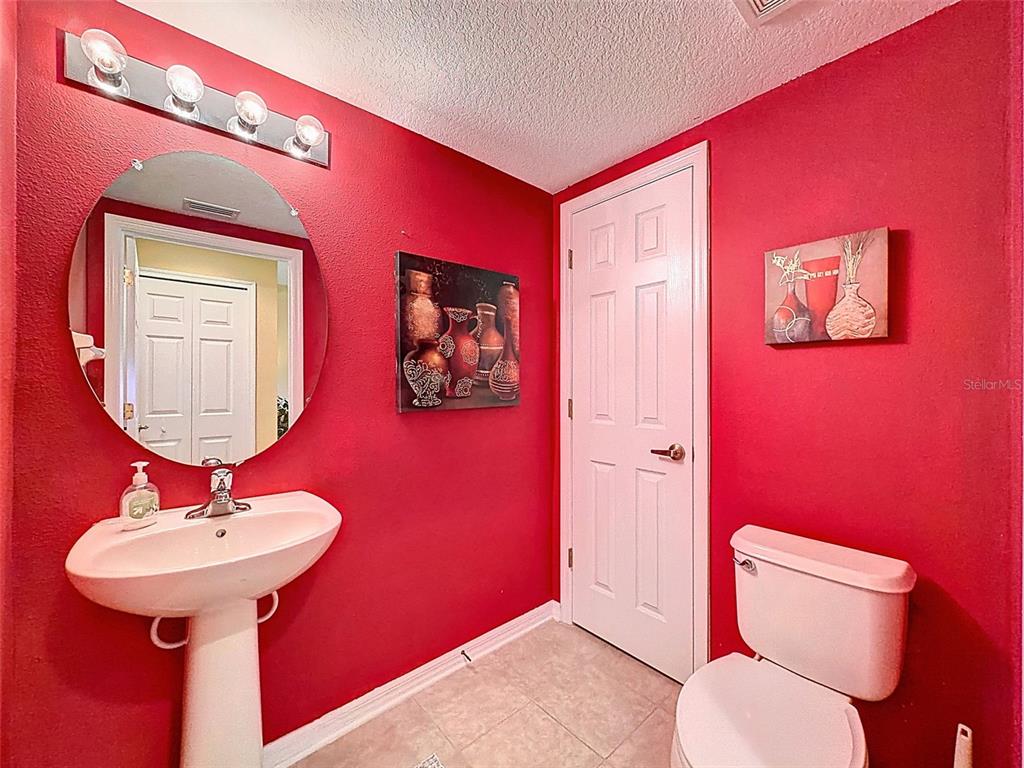 11807 Castine Street New Port Richey, FL 34654 - Photo 20 of 40 a bathroom with a toilet a sink and mirror