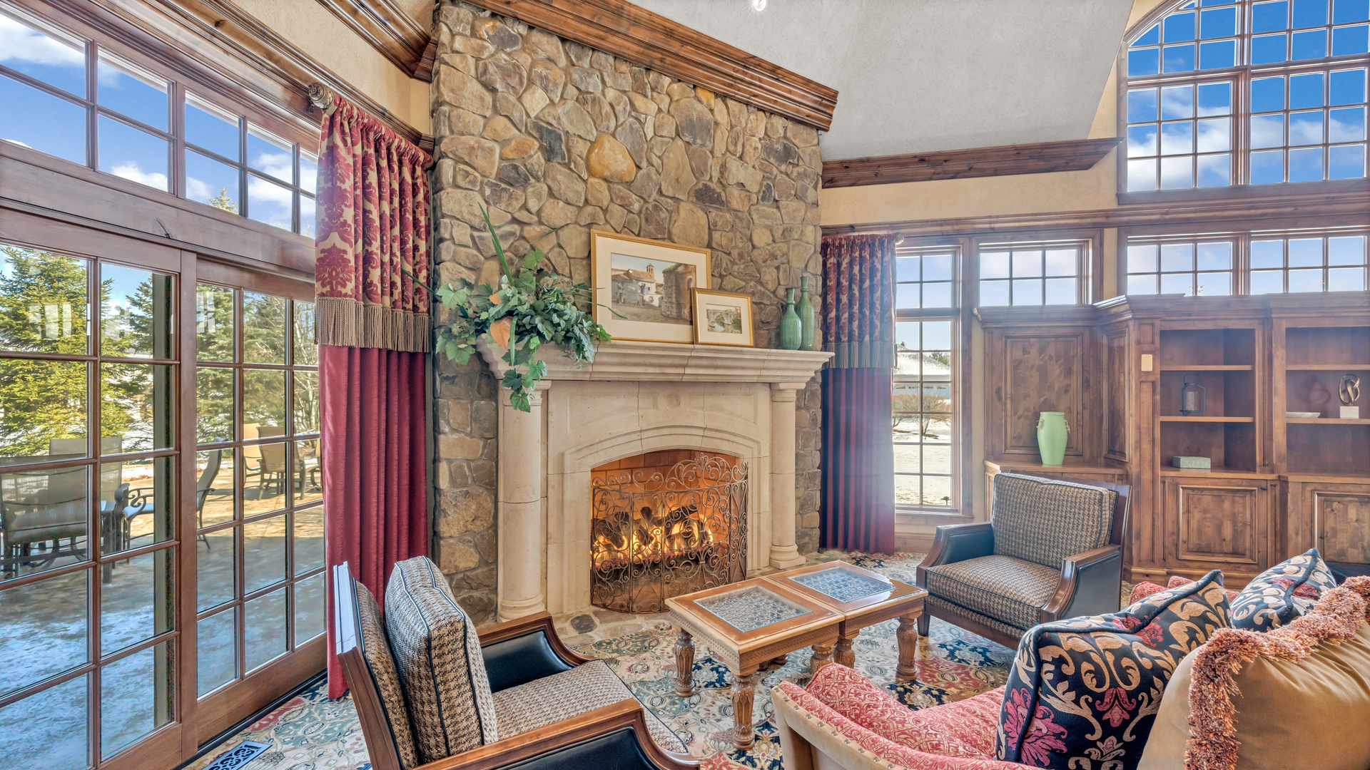 137 Singletree Road Orland Park, IL 60467 - Photo 20 of 75 a living room with furniture a fireplace and a floor to ceiling window