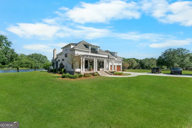 a aerial view of a house with swimming pool and green space