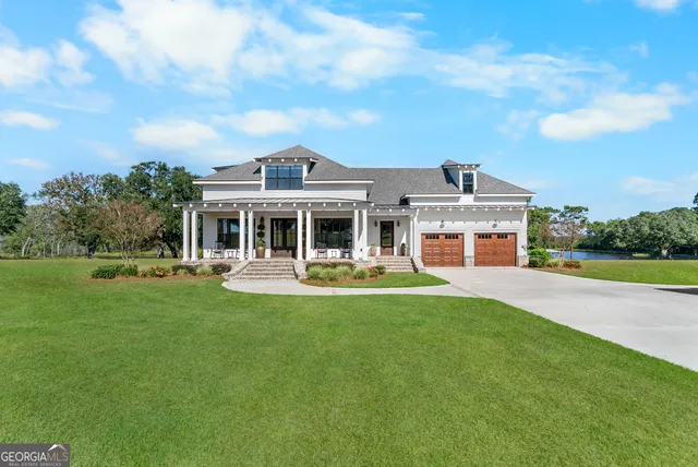 a front view of a house with a yard table and chairs
