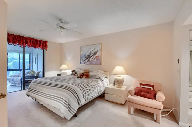 a bedroom with bed and a chandelier