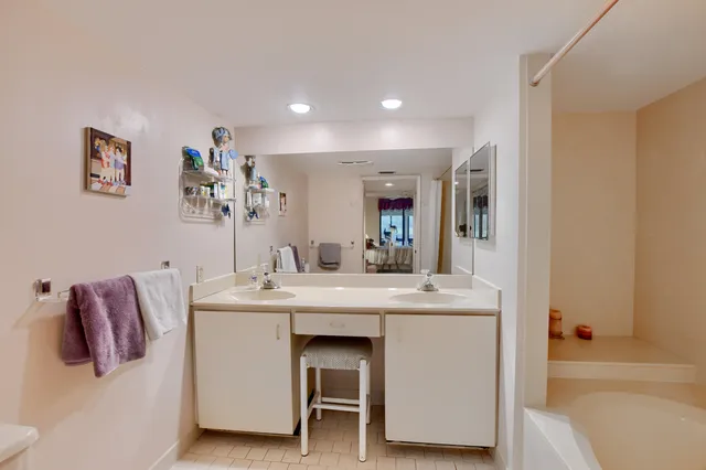 a white bath tub sitting next to a shower