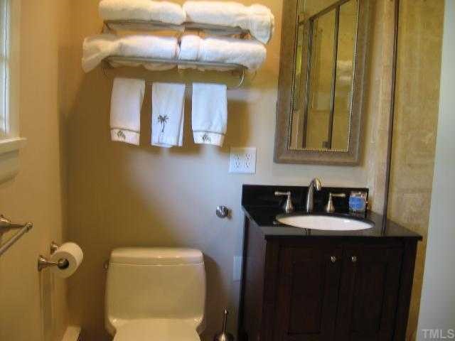 1408 Regent Place Raleigh, NC 27608 - Photo 8 of 12 a bathroom with a sink and a mirror