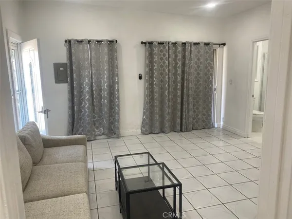 a bedroom with a bed and a chair