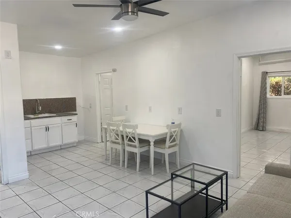 a dining room with furniture and a flat screen tv