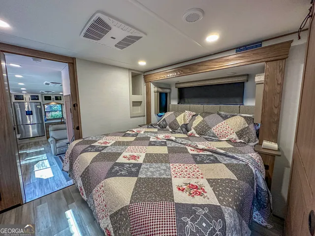 a spacious bedroom with a bed and a large mirror