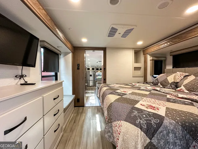 a spacious bathroom with a sink and mirror