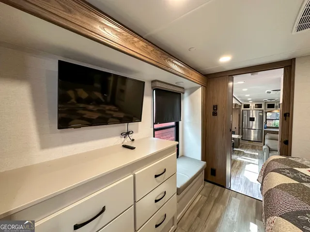 a bed sitting in a room next to a window