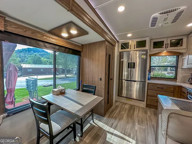a kitchen with stainless steel appliances granite countertop a refrigerator and a stove top oven