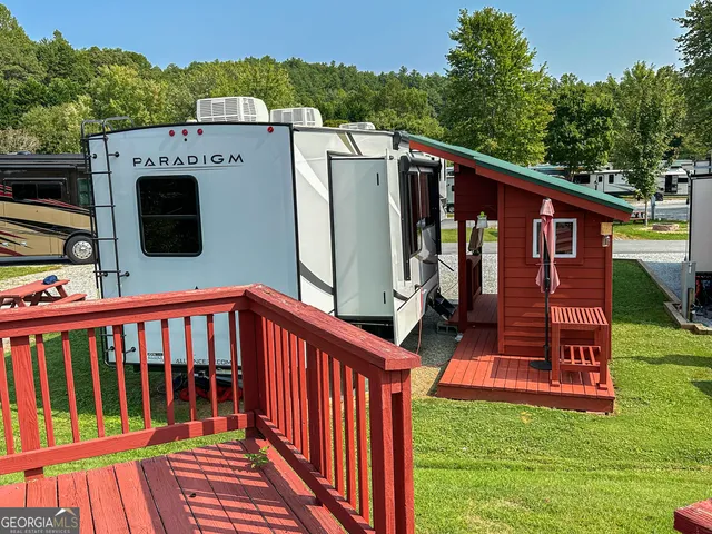 a view of a house with a deck and a yard
