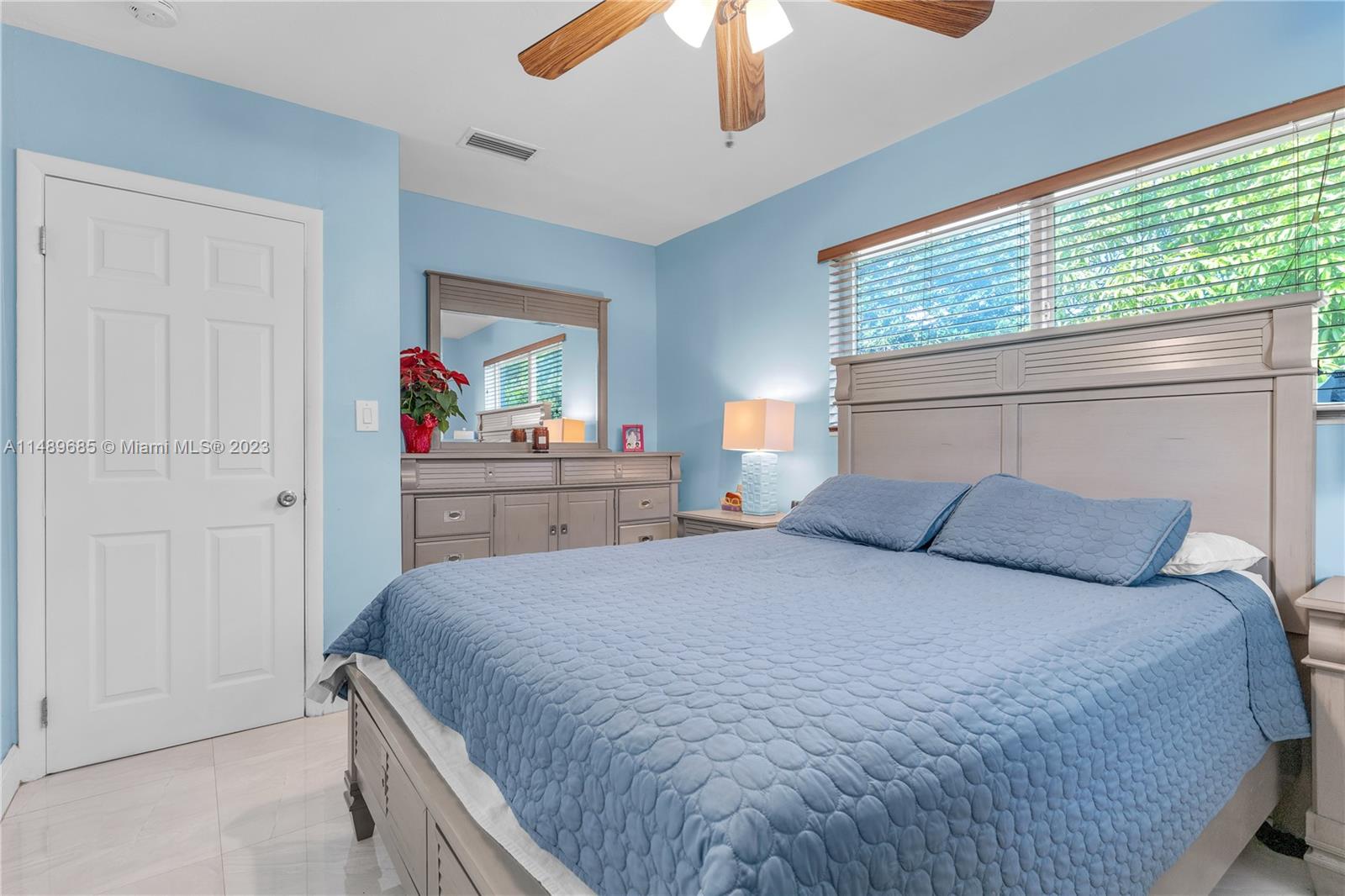 9511 Holiday Road Cutler Bay, FL 33157 - Photo 11 of 19 a bedroom with a bed and a chandelier