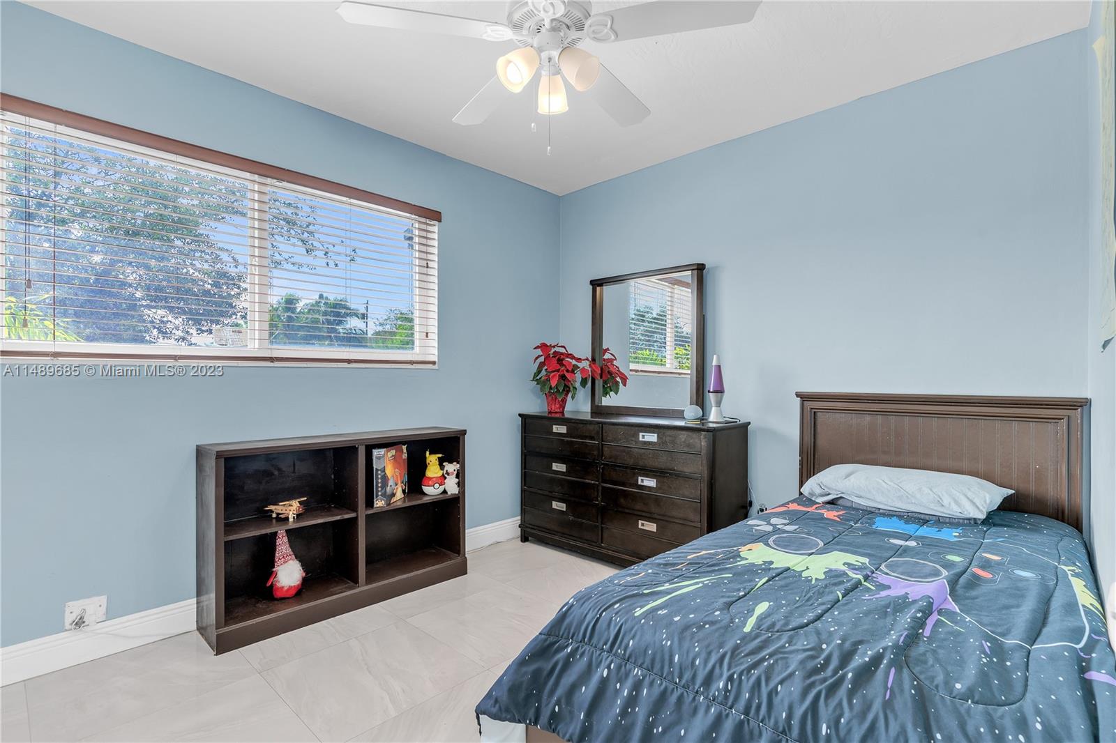 9511 Holiday Road Cutler Bay, FL 33157 - Photo 12 of 19 a bedroom with a bed and a chandelier