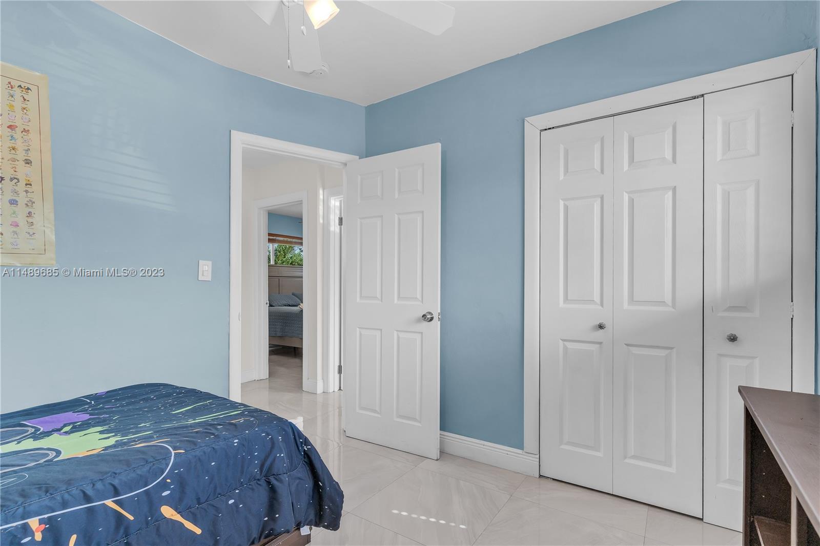 9511 Holiday Road Cutler Bay, FL 33157 - Photo 13 of 19 a bedroom with a bed and hallway