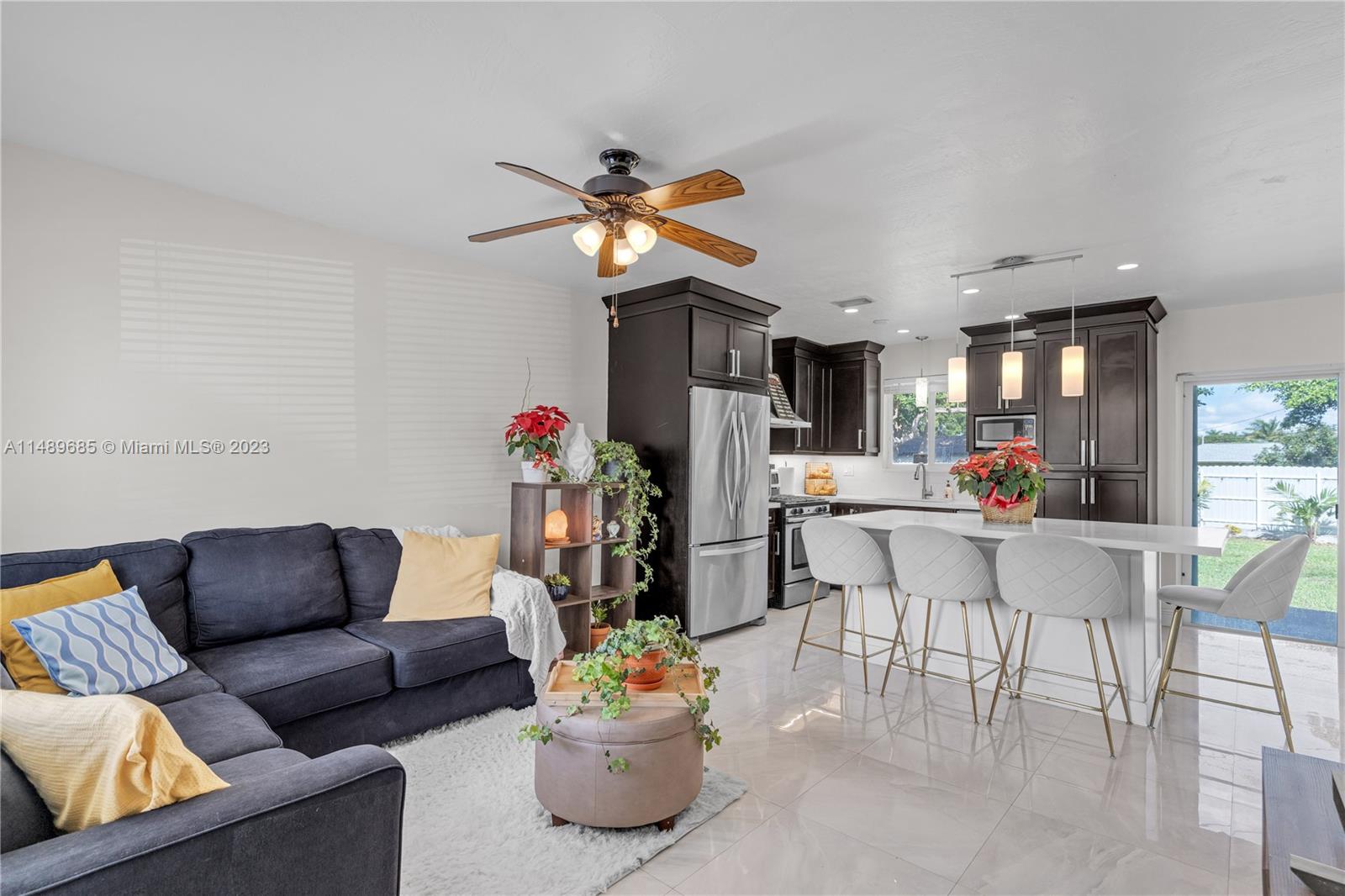 9511 Holiday Road Cutler Bay, FL 33157 - Photo 4 of 19 a living room with furniture a dining table and chairs with a dining table