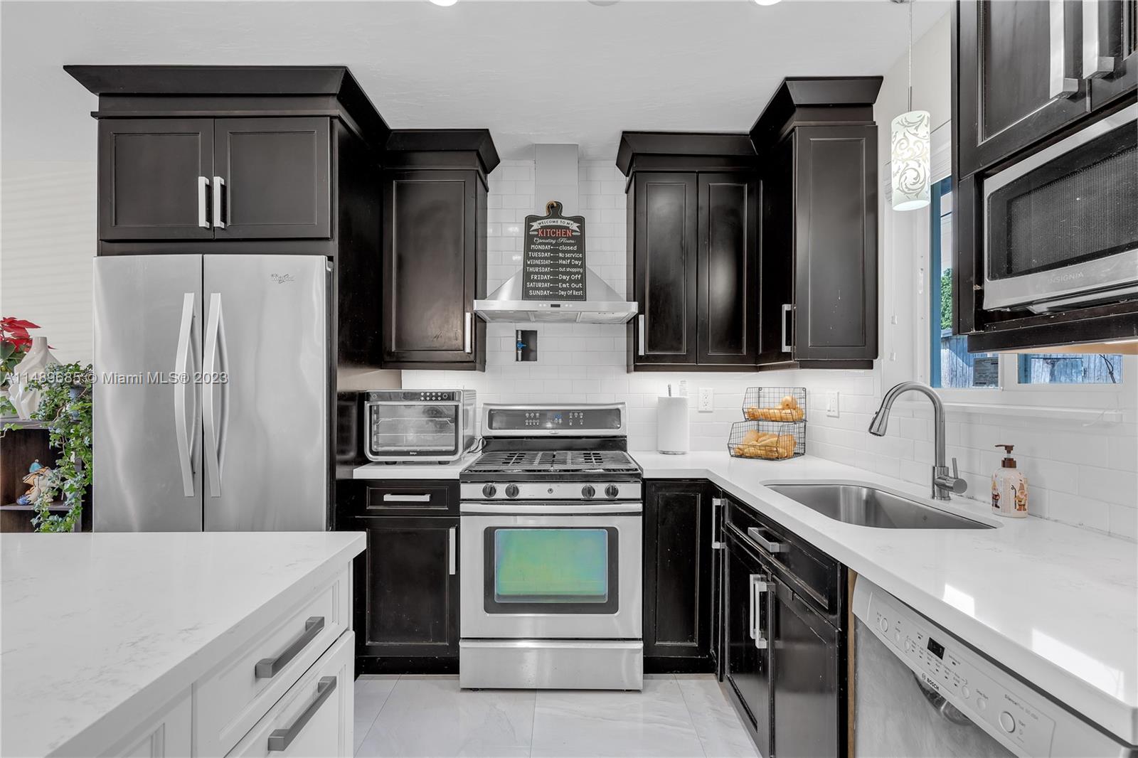 9511 Holiday Road Cutler Bay, FL 33157 - Photo 8 of 19 a kitchen with stainless steel appliances a stove microwave and refrigerator