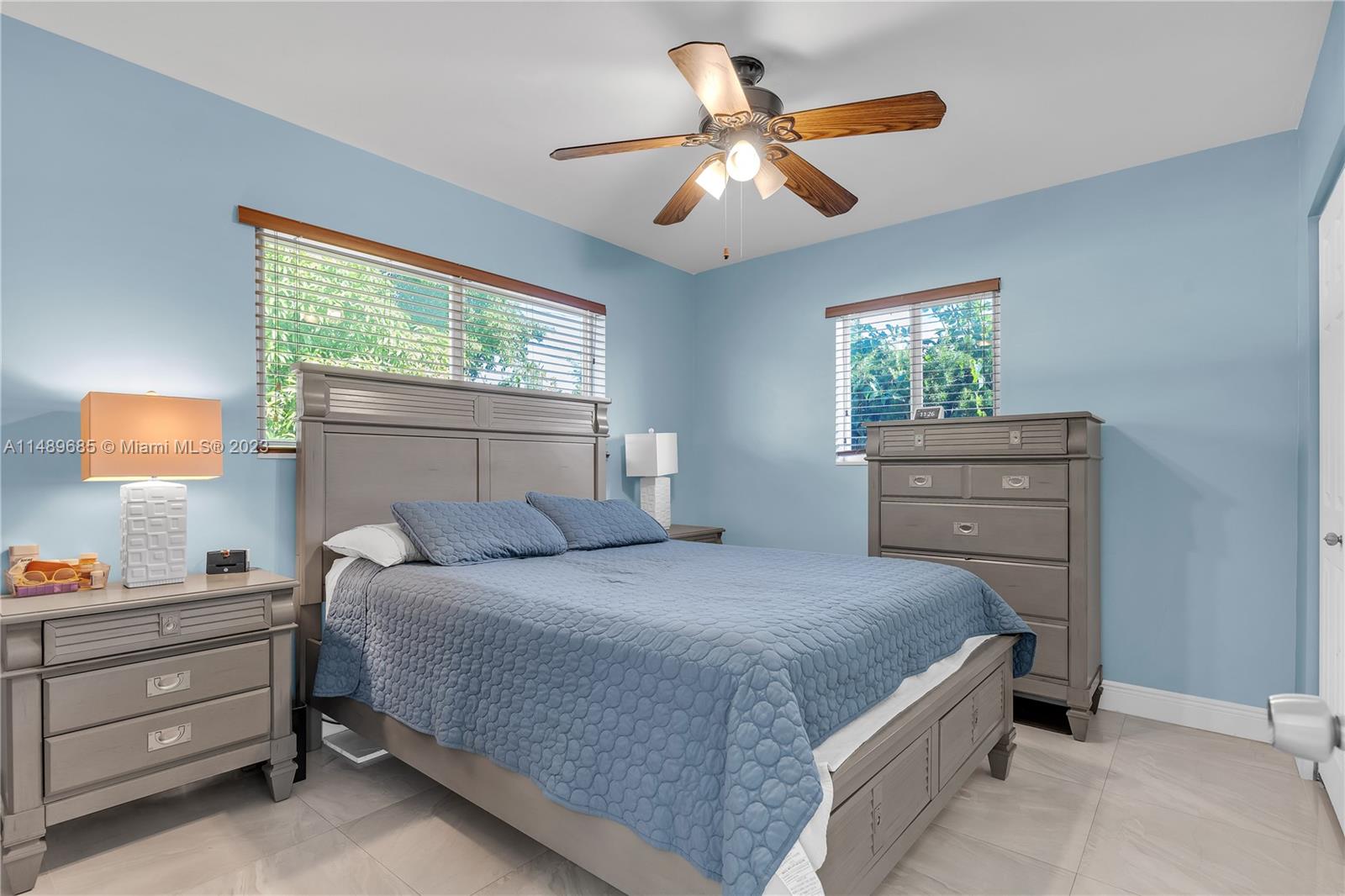 9511 Holiday Road Cutler Bay, FL 33157 - Photo 10 of 19 a bedroom with a bed and a chandelier