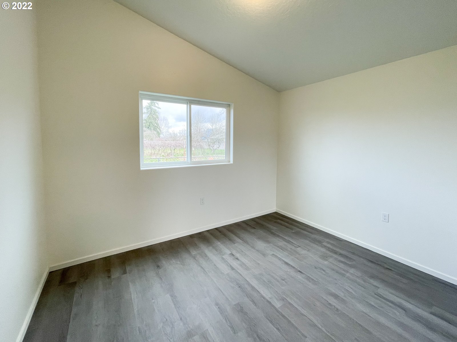 305 39th Street Springfield, OR 97478 - Photo 8 of 16 an empty room with wooden floor and windows