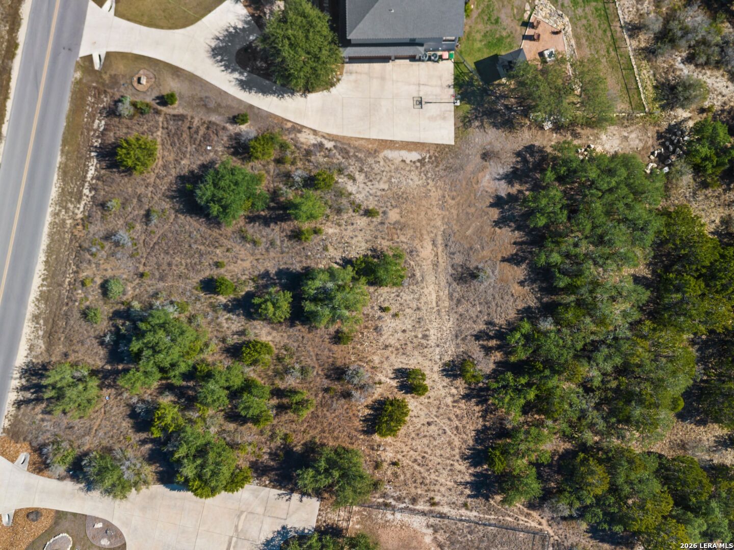 344 Quest Spring Branch, TX 78070 - Photo 14 of 16 an aerial view of a house with a yard and trees