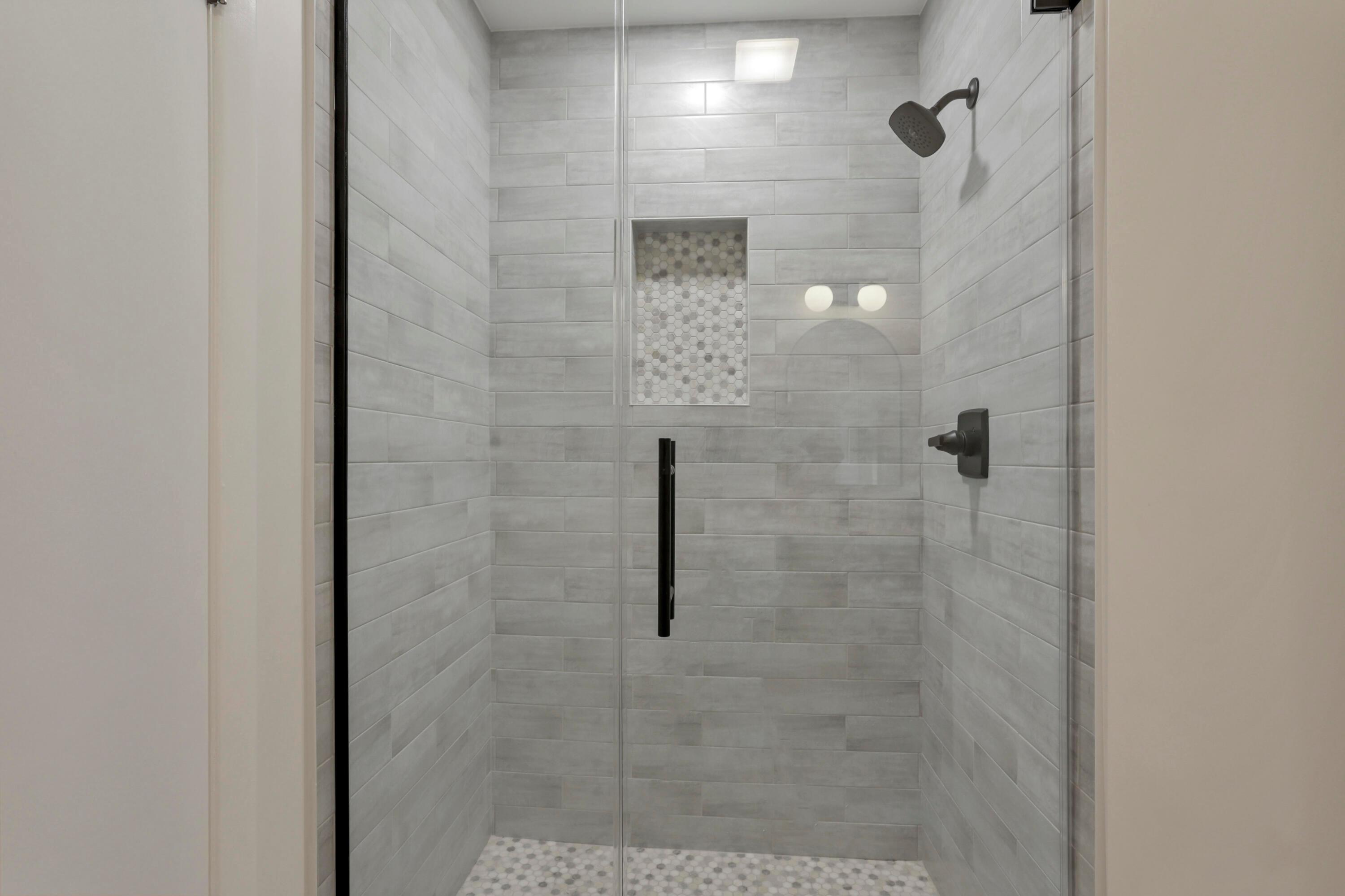 2275 Haverford Road Columbus, OH 43220 - Photo 23 of 57 The full bathroom on the first floor features new tile, vanity, fixtures and walk-in shower with glass door.