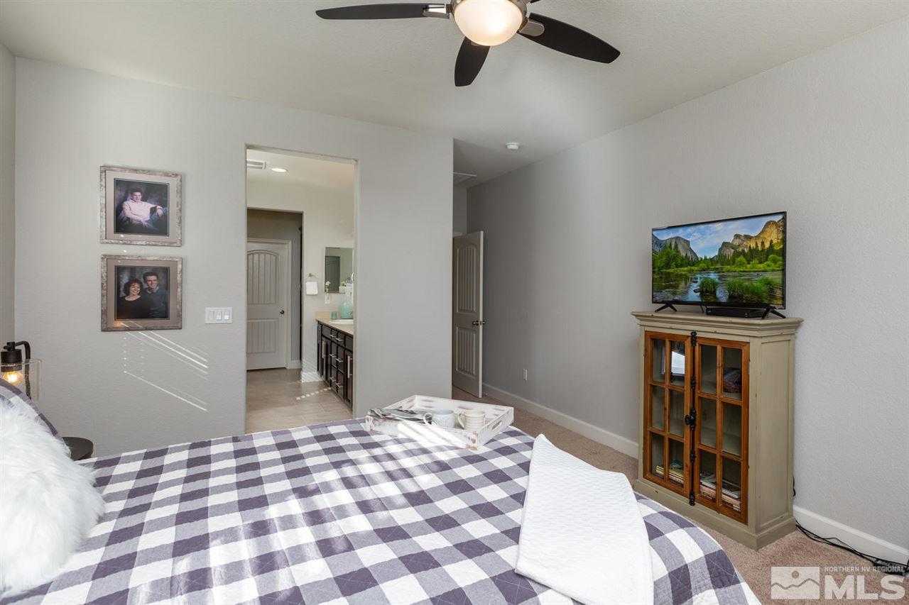 1830 Cascade Stable Lane Reno, NV 89521 - Photo 13 of 25 a bedroom with a bed and a flat screen tv