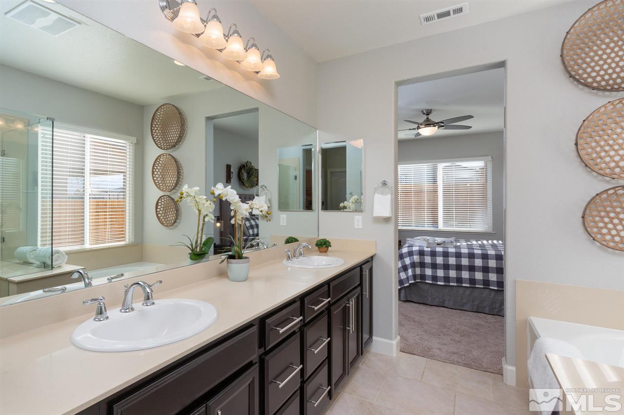 1830 Cascade Stable Lane Reno, NV 89521 - Photo 14 of 25 a bathroom with a sink a mirror and a shower