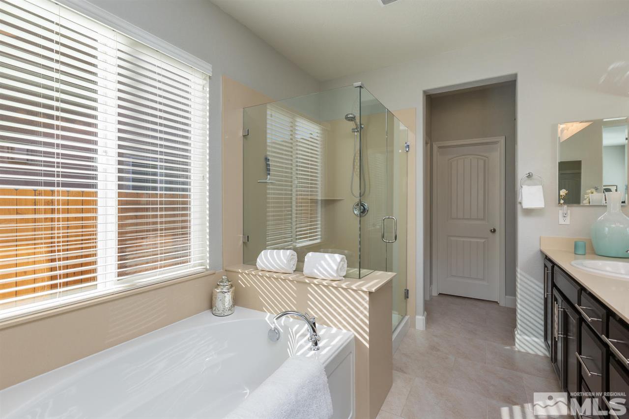 1830 Cascade Stable Lane Reno, NV 89521 - Photo 15 of 25 a bedroom with a bed and a chandelier