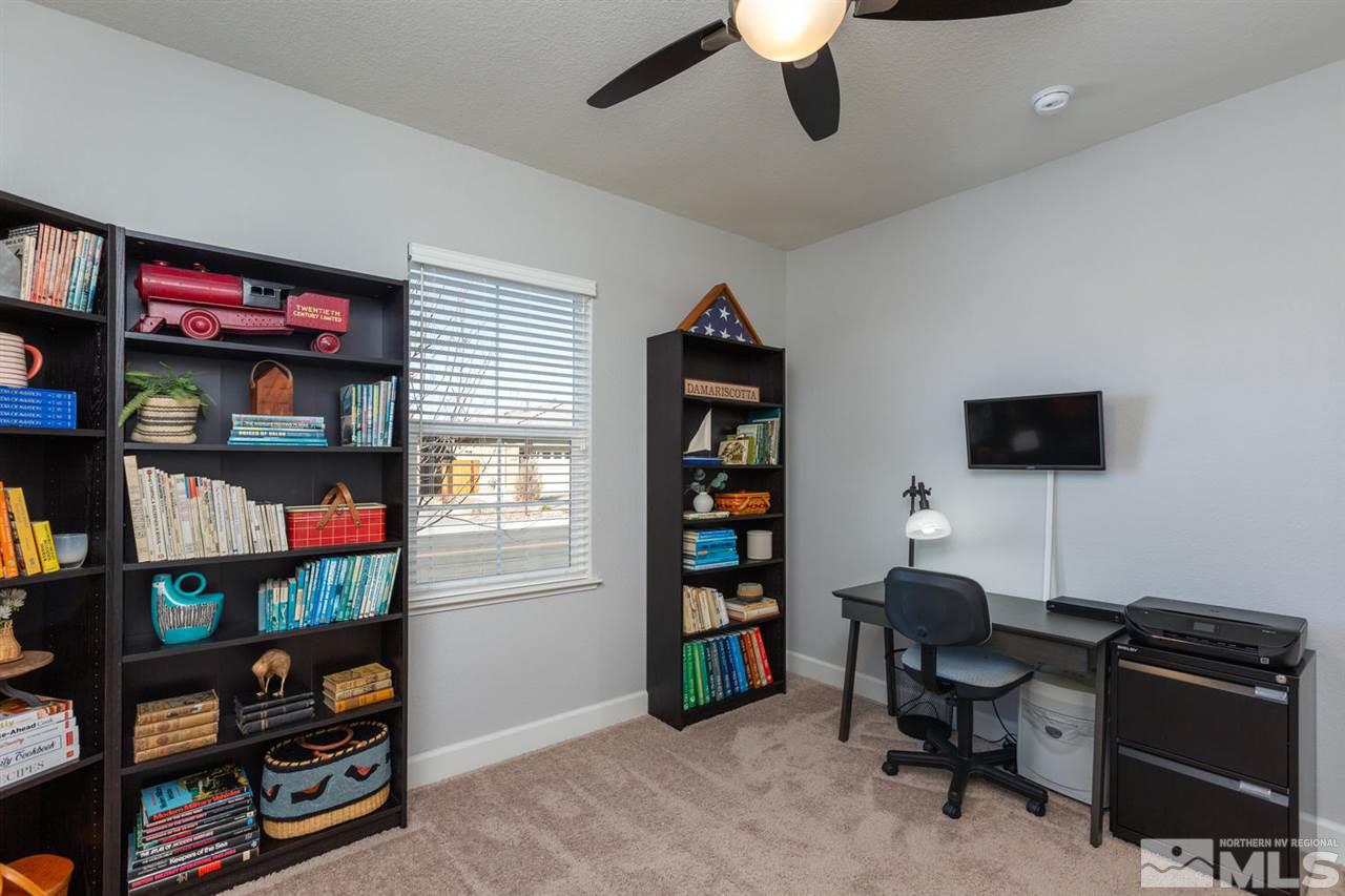 1830 Cascade Stable Lane Reno, NV 89521 - Photo 18 of 25 a view of a workspace with bookshelf and a window